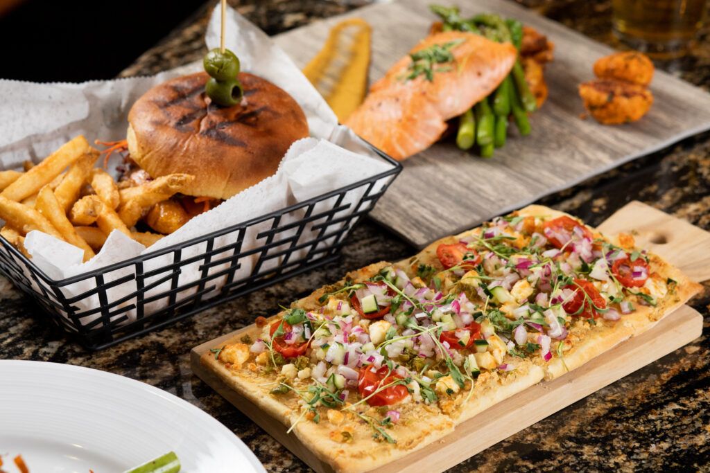Flatbread, salmon, and delicious burgers featured at 1899 Bar and Grill.