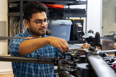 An N A U mechanical engineering student works on a project on campus.