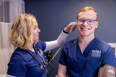 N A U Nursing students practice examining classmates.