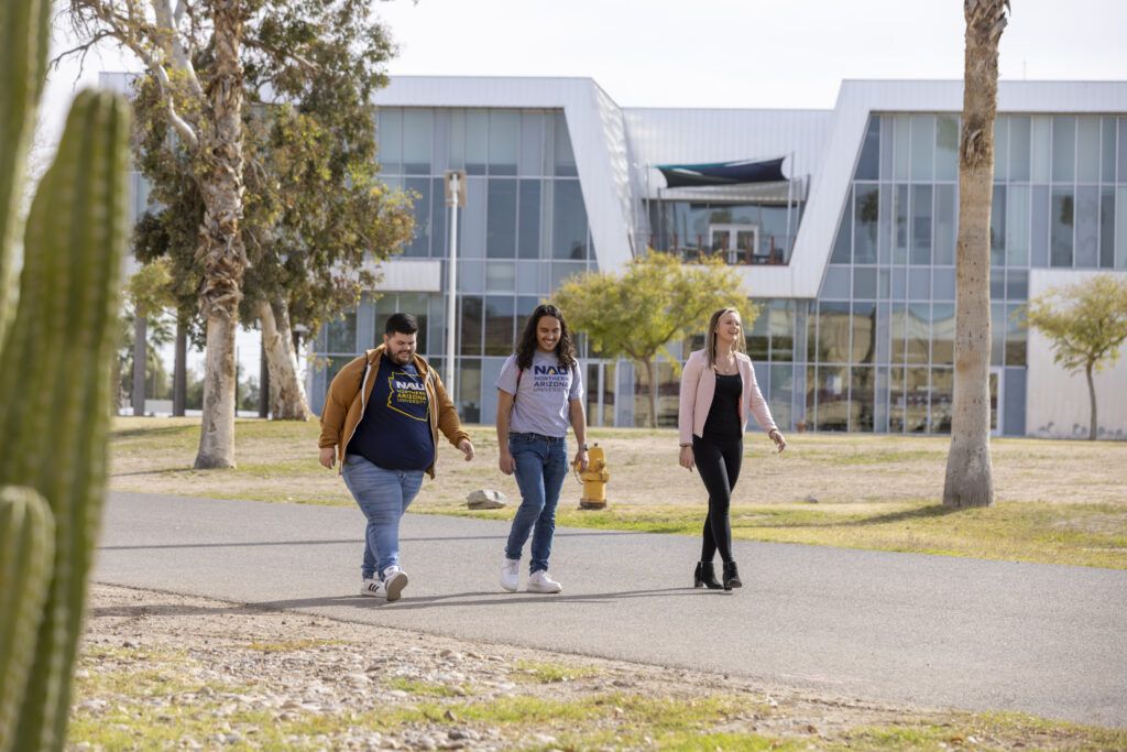 Three N A U students walking on the Yuma campus.