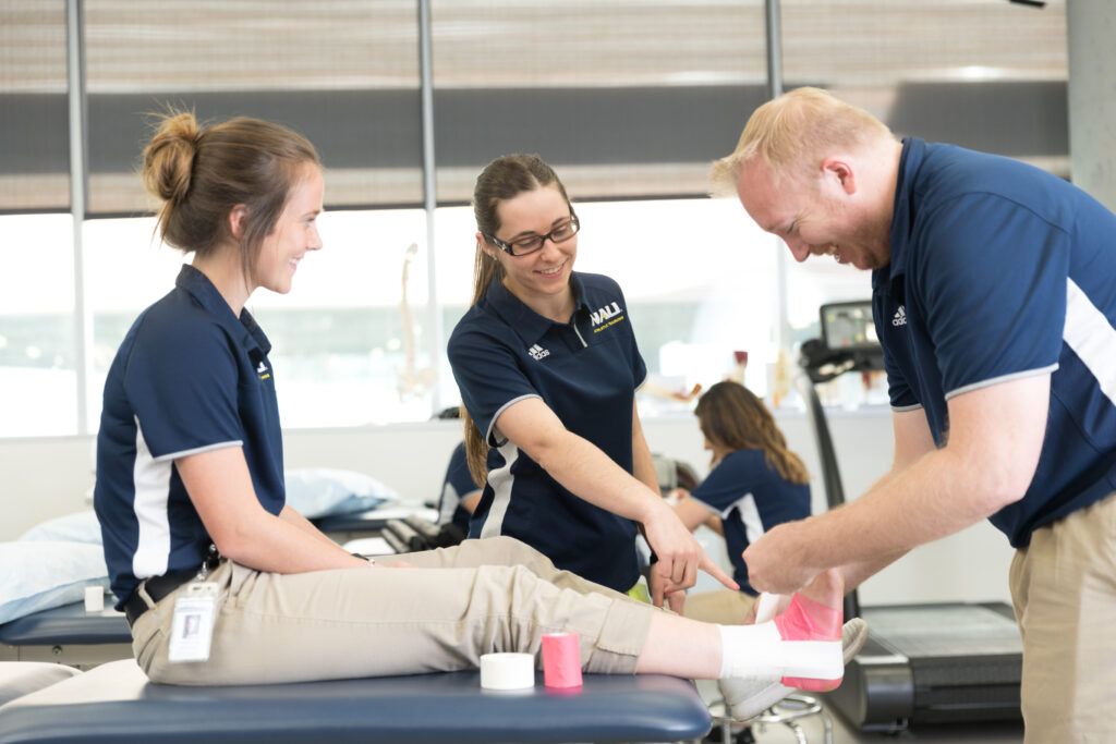 Students at the Phoenix Bioscience Core practice wrapping an ankle.