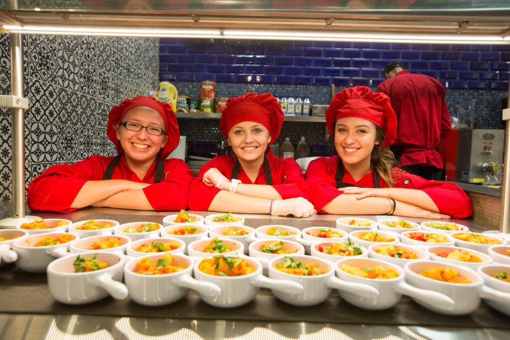Students cooks at the DuB dining hall take a picture with their prepared meals.