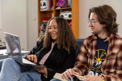 N A U students laugh during a study session in their campus residence.